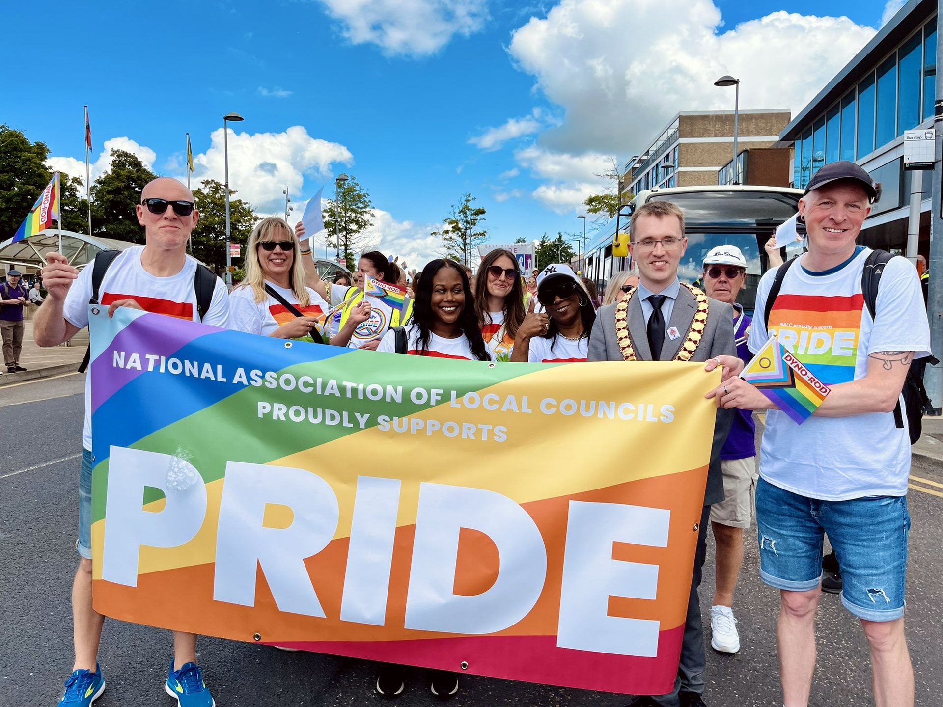 KALC and NALC staff in the Corby Pride parade, holding the Pride banner